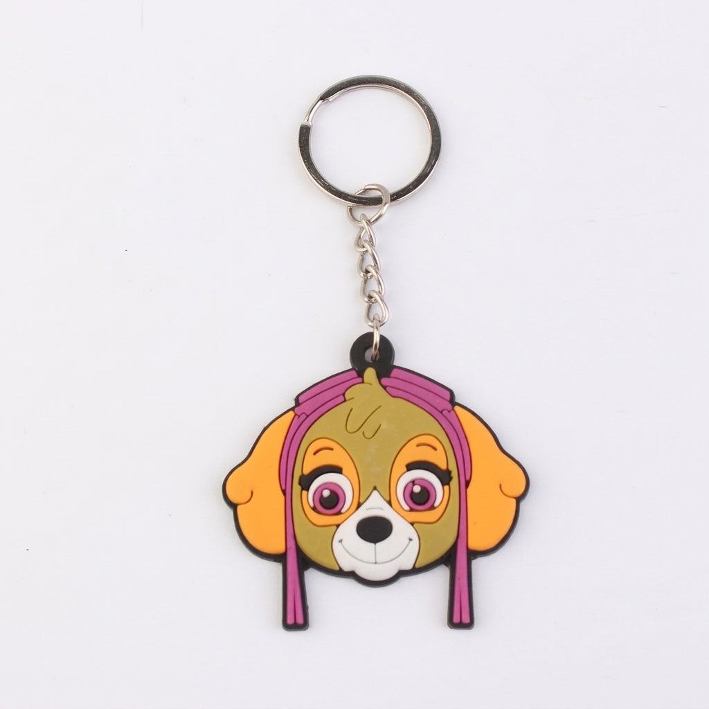 Porte-clés Pat Patrouille Stella en forme de tête de chien jaune et rose.