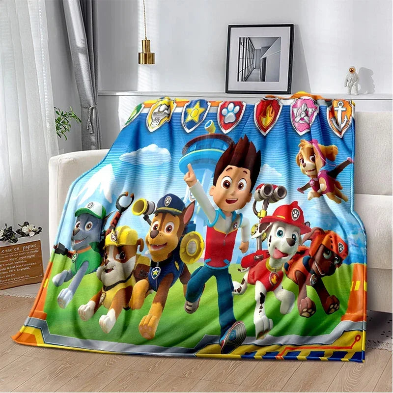 Plaid enfant bleu et vert Pat Patrouille avec personnages et badges Ryder, bord orange